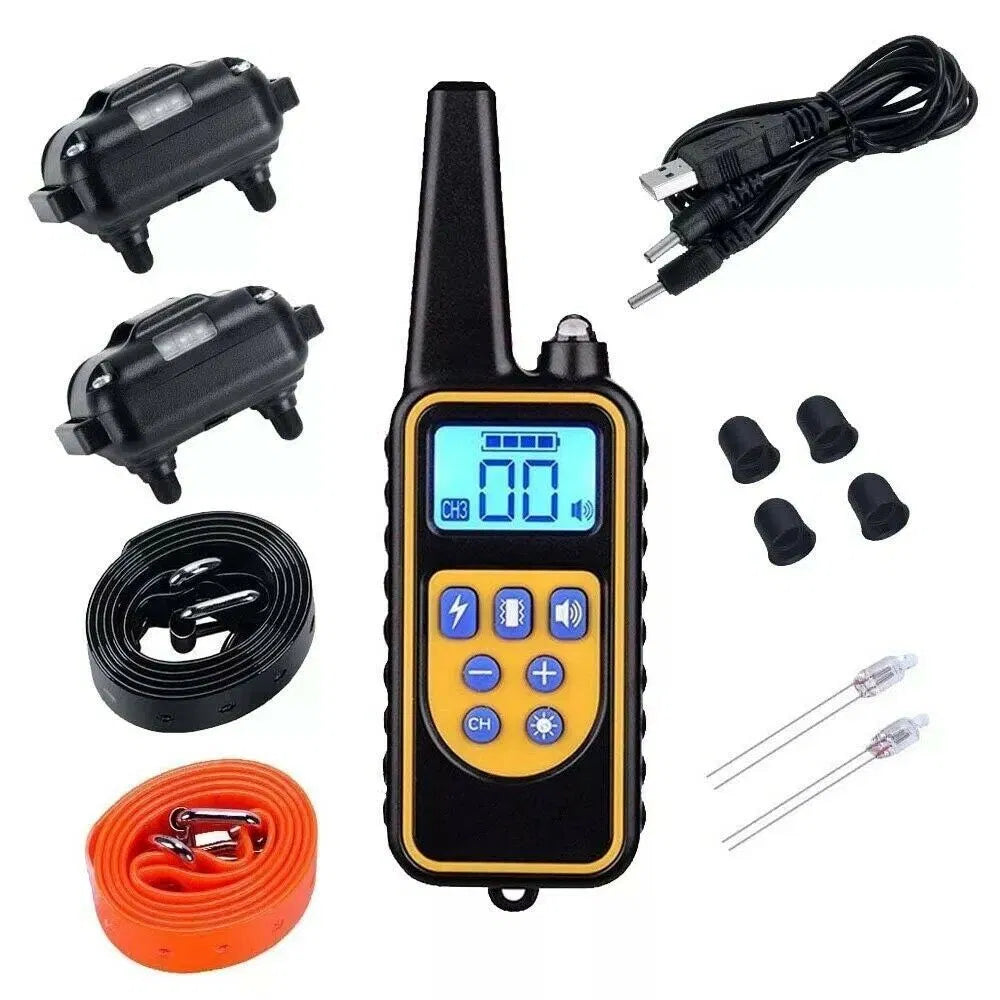 Remote dog training collar kit laid out: two receivers, LCD remote, USB cable, contact points and two straps