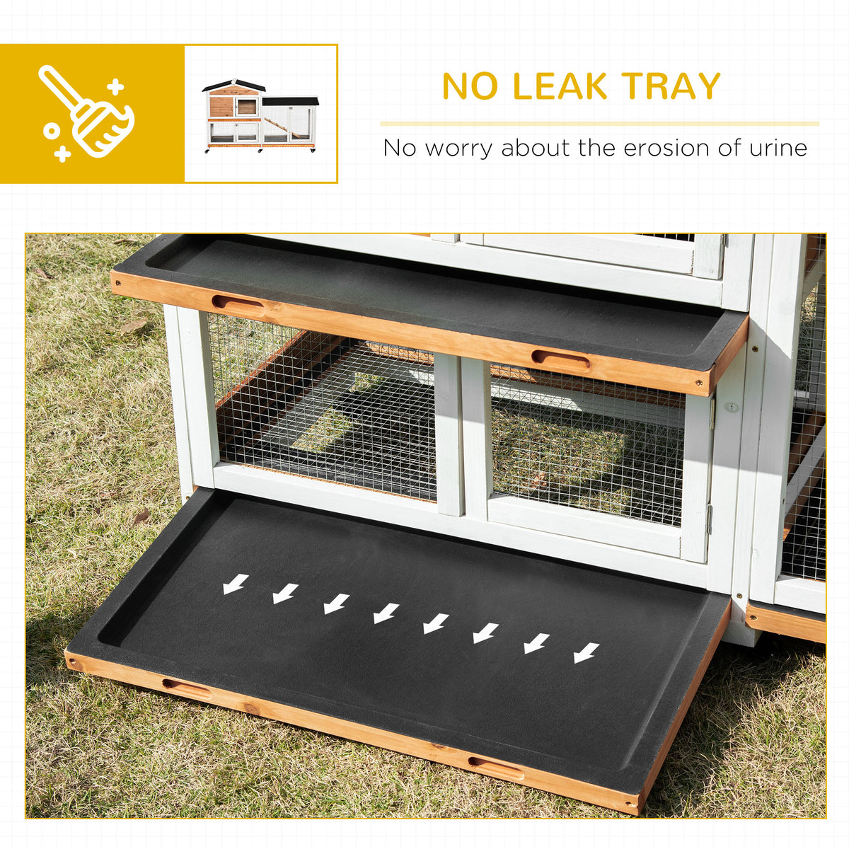 White and wood rabbit hutch on grass with its black leak-proof tray pulled out
