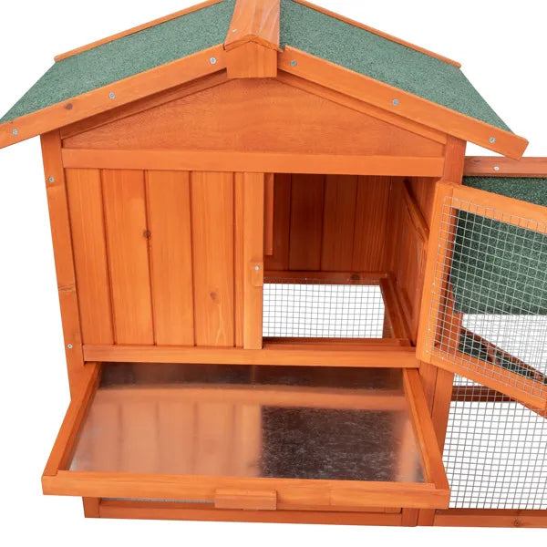 Orange-stained wooden animal house with a green apex roof, open front and an attached wire mesh run