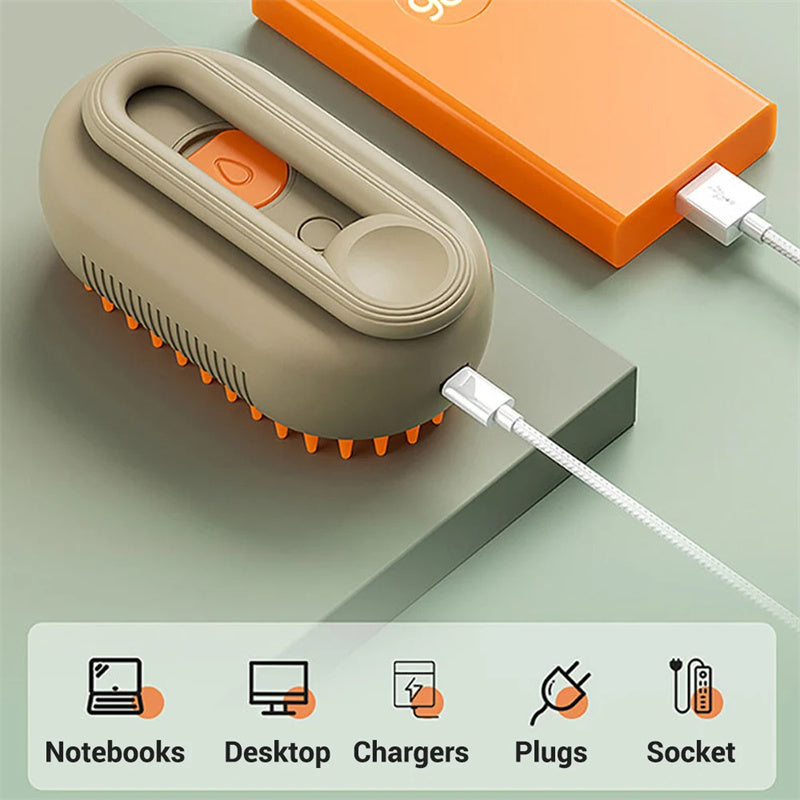 Sage and orange steam pet grooming brush with its USB cable, beside icons of devices it can charge from