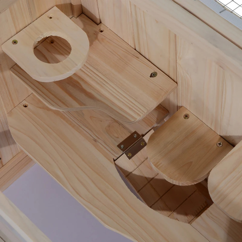 Close-up of the wooden platform opening and hinged ramp inside the hamster cage