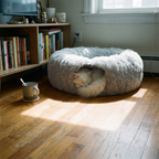 Long-haired white cat curled inside the plush cat tunnel bed in an apartment living room - lifestyle v2