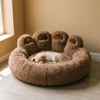 Brown paw-shaped plush fleece pet cuddler bed in a living room - wrenwood hero