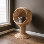Woven rattan egg-chair cat bed on a pedestal base with a cat sitting inside - wrenwood hero