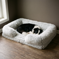 White shaggy plush winter pet bed in a living room with a small dog curled inside - wrenwood hero