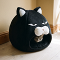 Black plush cat-face covered pet bed nest with a grey cat peeking out of the opening - wrenwood hero