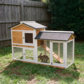 Large wooden rabbit hutch with run and ramp on backyard grass - wrenwood hero