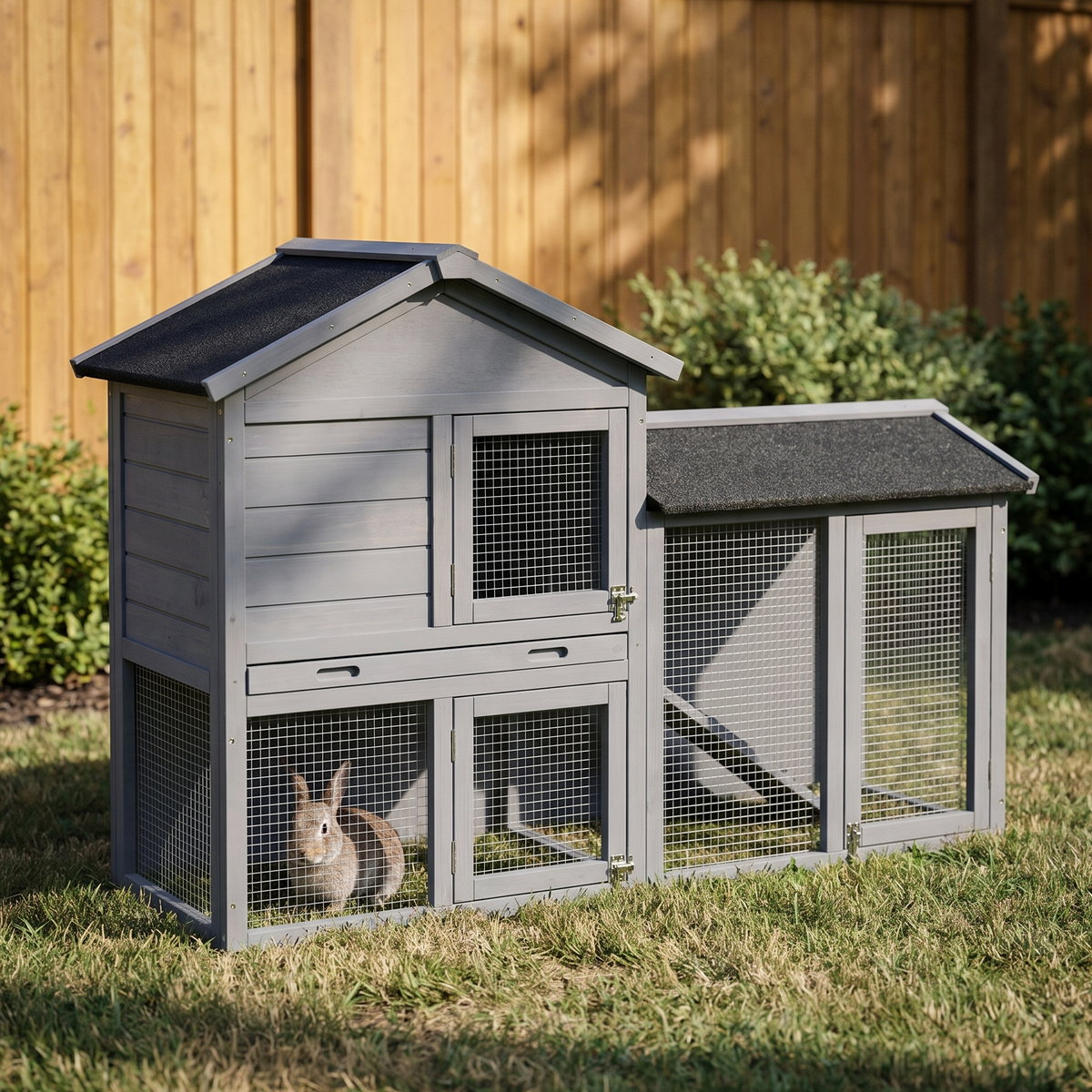 Gray wooden outdoor rabbit hutch with run and ramp on backyard grass - wrenwood hero