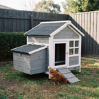 Grey and white wooden chicken coop with ramp in a backyard - wrenwood hero