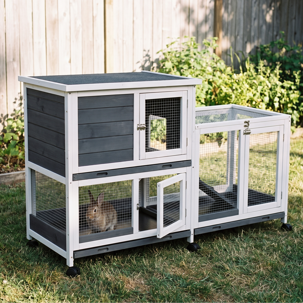 Elevated two-tier wooden rabbit hutch with ramp and wheels - wrenwood hero