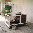 Rolling wooden rabbit cage with pull-out tray and run on a patio - wrenwood hero