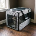 Grey soft-sided foldable pet carrier in a home entryway with a small dog inside - wrenwood hero