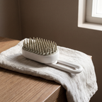 Steam pet grooming brush on a linen cloth in a home bathroom - wrenwood hero