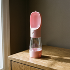 Portable pet travel water bottle standing on an oak sideboard - wrenwood hero