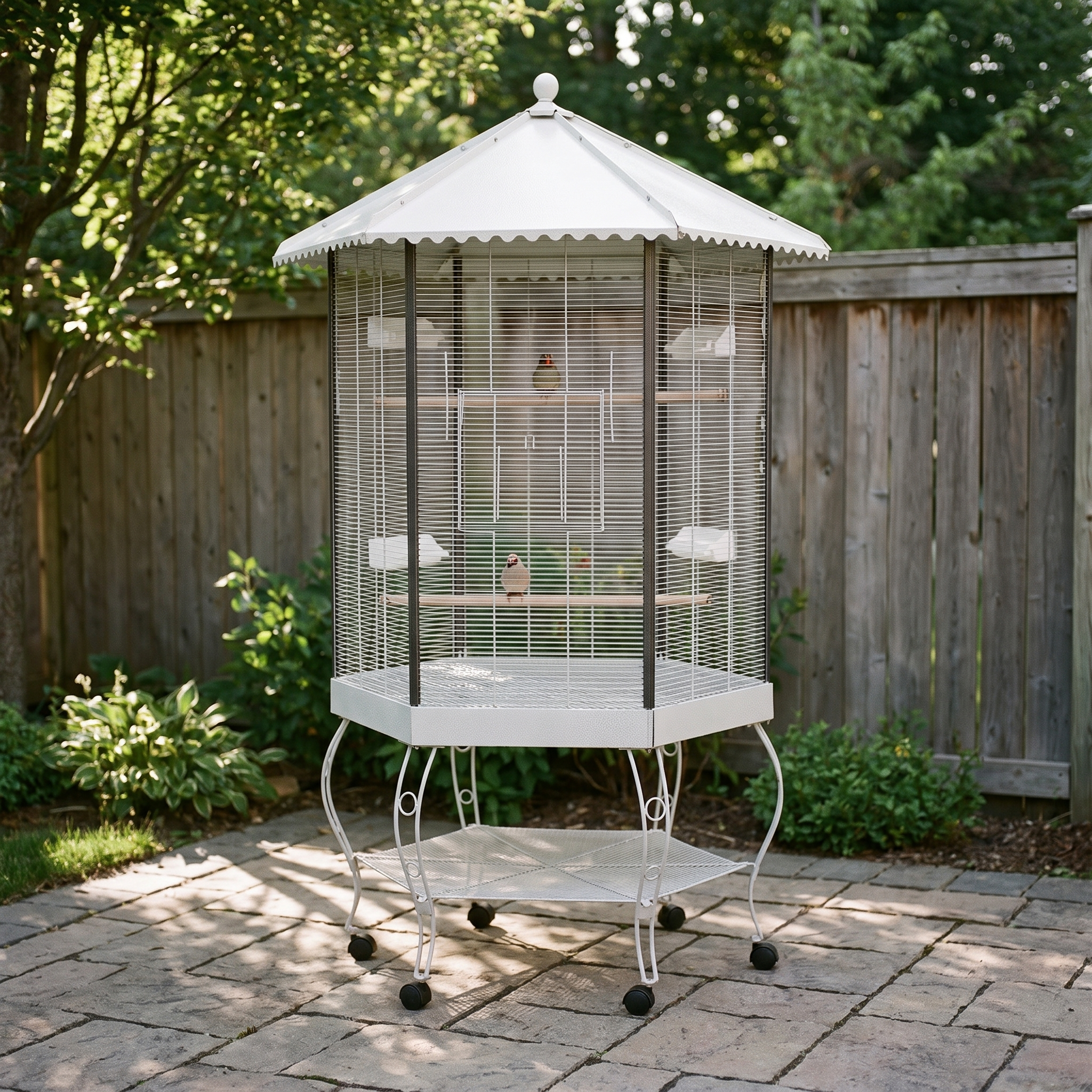 Hexagonal flight bird cage with canopy and stand on a garden patio - wrenwood hero