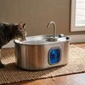 Stainless steel pet water fountain on a jute rug with a tabby cat drinking - wrenwood hero