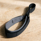 Hands-free padded nylon dog walking wrist strap on a wooden table - wrenwood hero