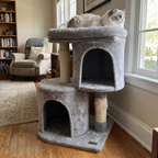 Compact grey cat tree in a living room corner with cat perched on top - wrenwood hero v2
