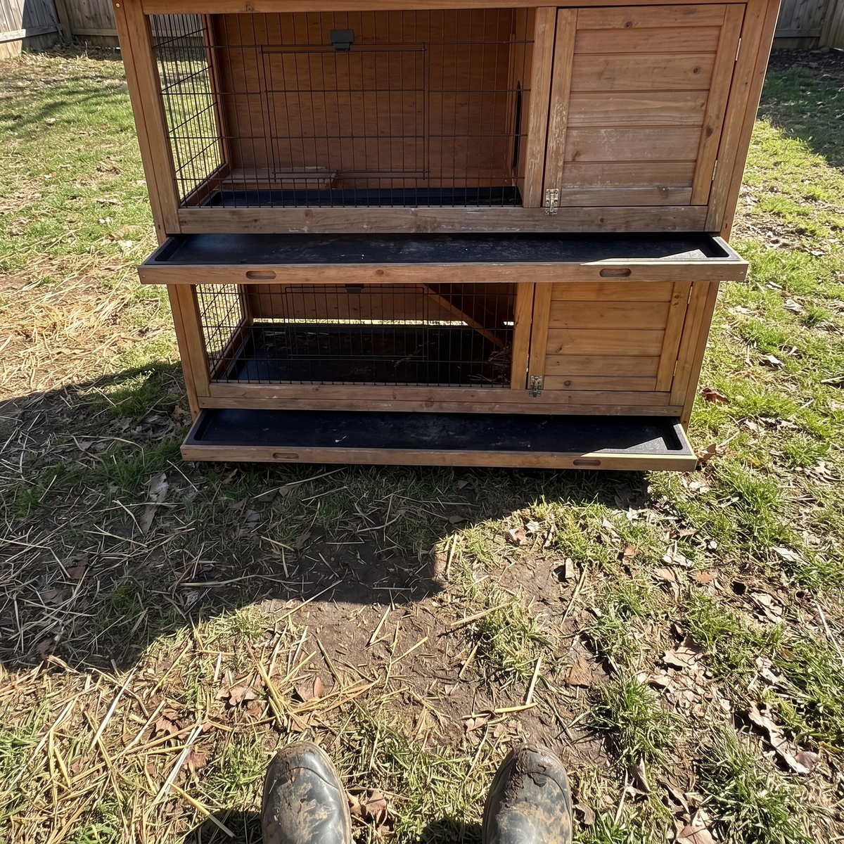 owner's boots by the two-story rabbit hutch in a worn backyard - wrenwood ugc lifestyle v2