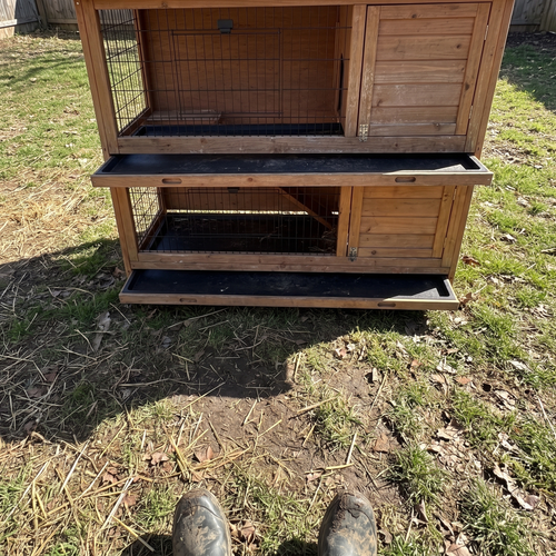 owner's boots by the two-story rabbit hutch in a worn backyard - wrenwood ugc lifestyle v2
