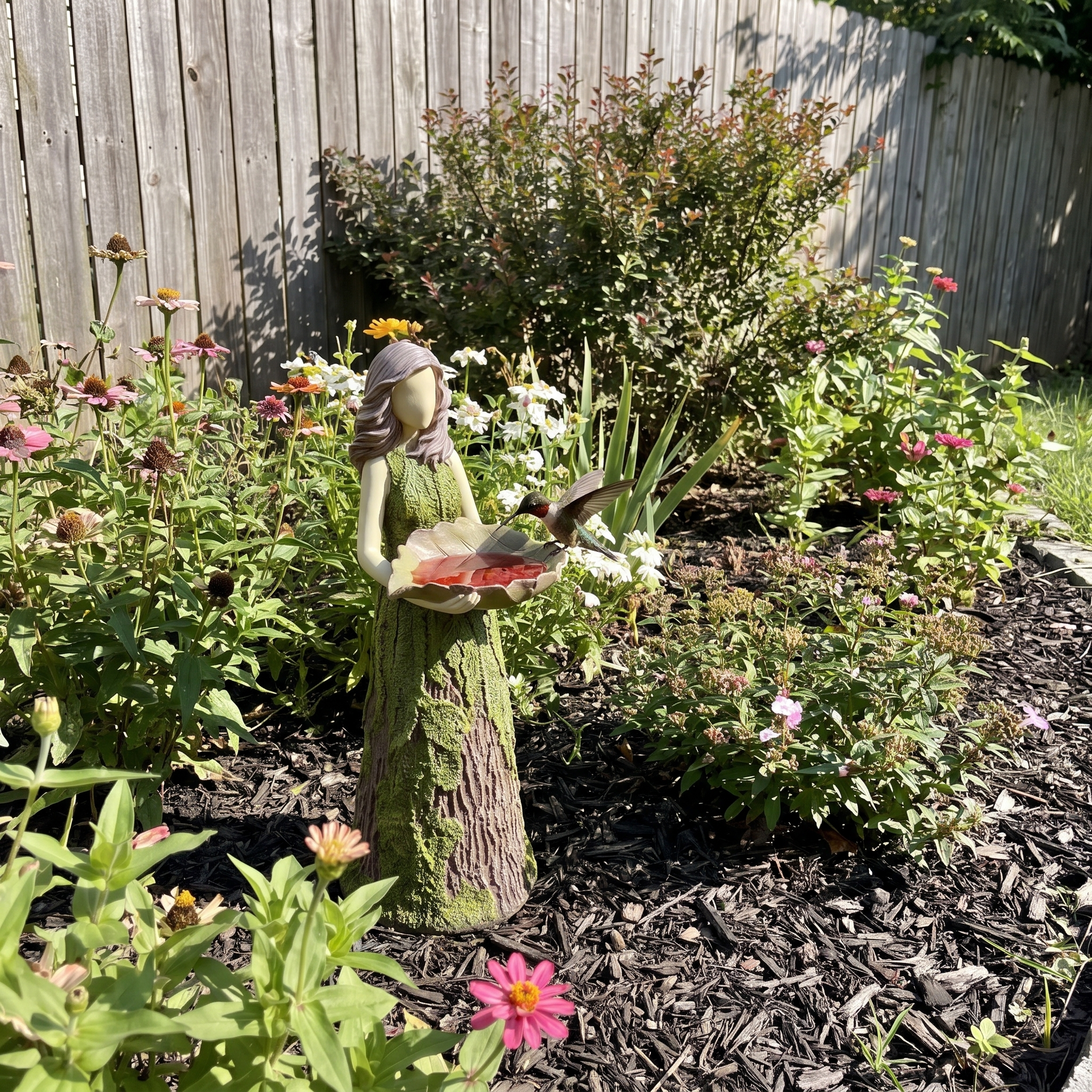 Fairy hummingbird feeder among garden flowers with a hummingbird hovering - wrenwood ugc lifestyle v2