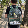 Owner from behind wearing the green parrot travel backpack with a cockatiel inside - wrenwood ugc lifestyle v2