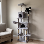 Tuxedo cat resting on an upper platform of the 80in cat tree tower in a lounge corner