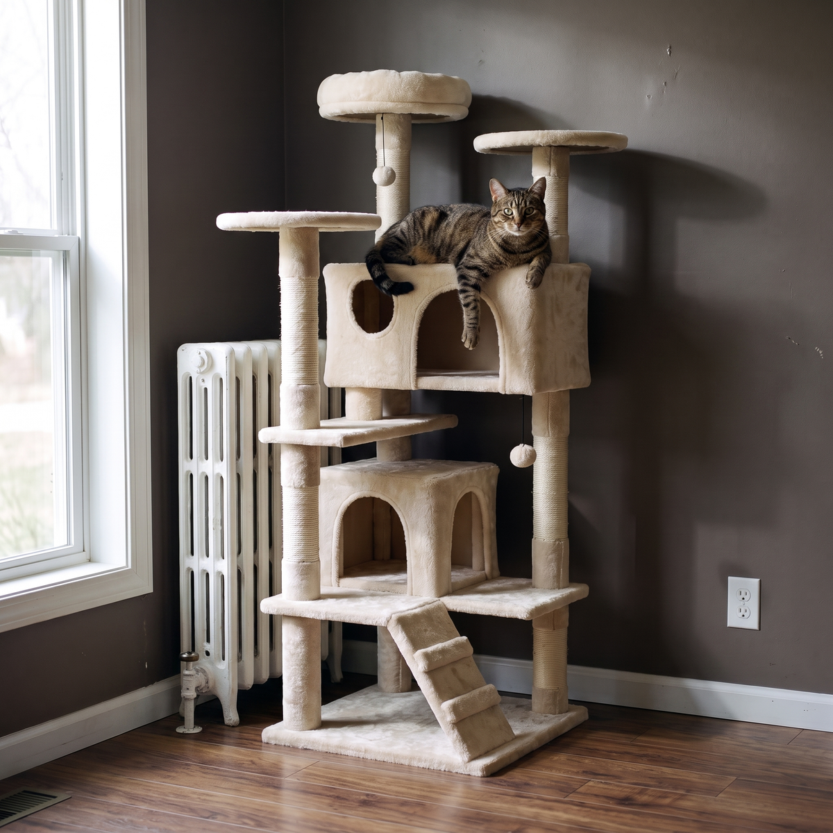 Brown tabby cat resting on a middle perch of the cream 52in cat tree tower in a bright lounge beside a radiator