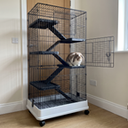 Rabbit on a middle platform of the 6-tier rolling wire small-animal cage in a spare room