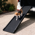 A black pet ramp with a beagle walking up it, positioned next to an open white vehicle door in a driveway.